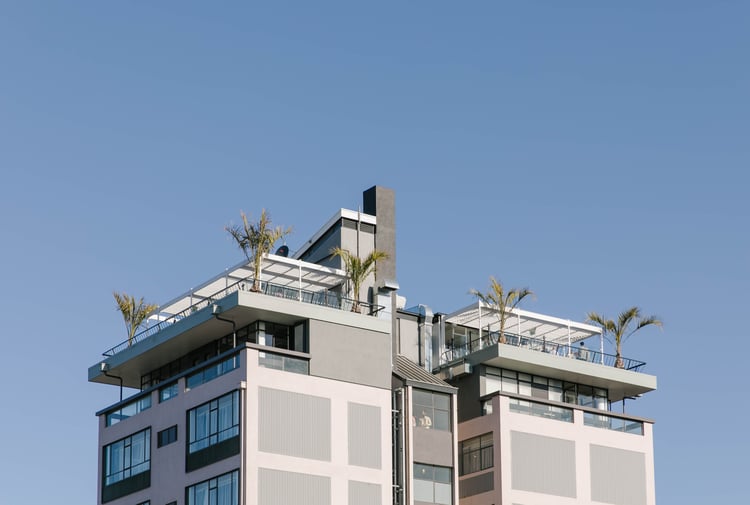 A view of the Pink Lady building looking up from the ground.