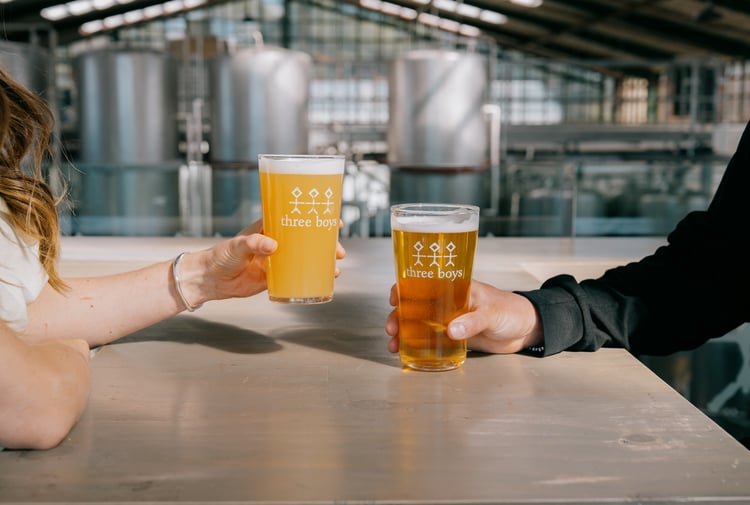 Two pints of Three Boys Brewery beers on the table.