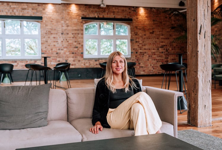 Holly Schröder sat on couch at Textile Loft.