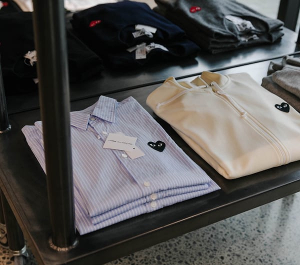 Close up of CDG play shirts at PLUME.
