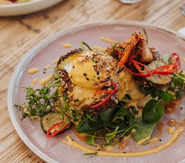A plate of brunch on a table at Buster Greens.