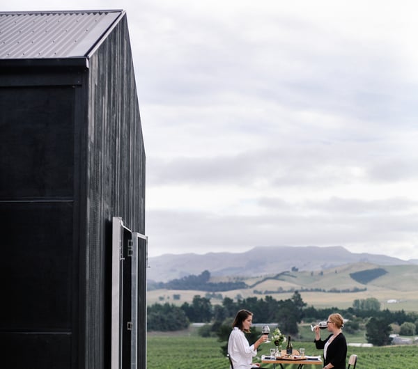 Two woman dining outside at Black Estate.