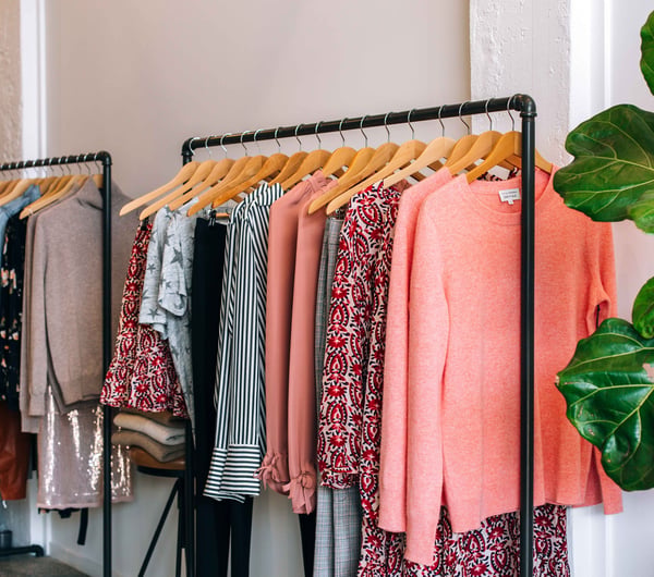 Pink clothes on racks.