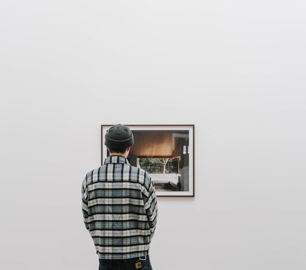 Man looking art at CoCA.