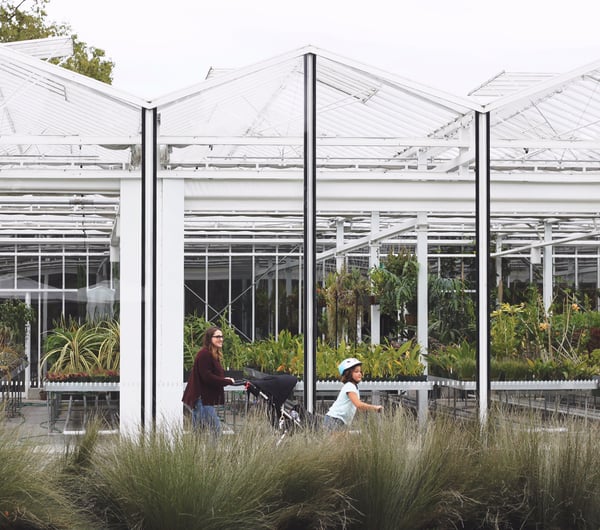 Woman with two children walking through the botanical gardens in Christchurch.