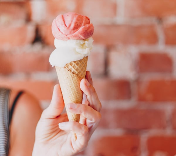 A hand holding an ice cream.
