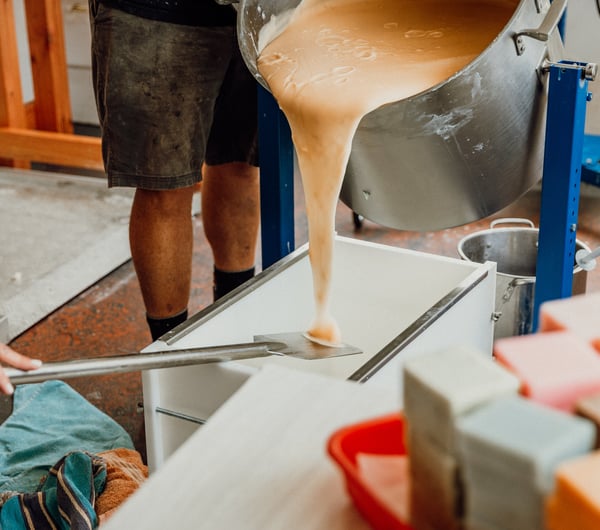 Liquid soap being poured on to a table ready for setting.