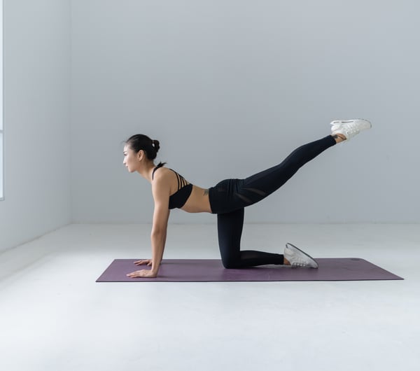 A woman doing yoga in a studio.
