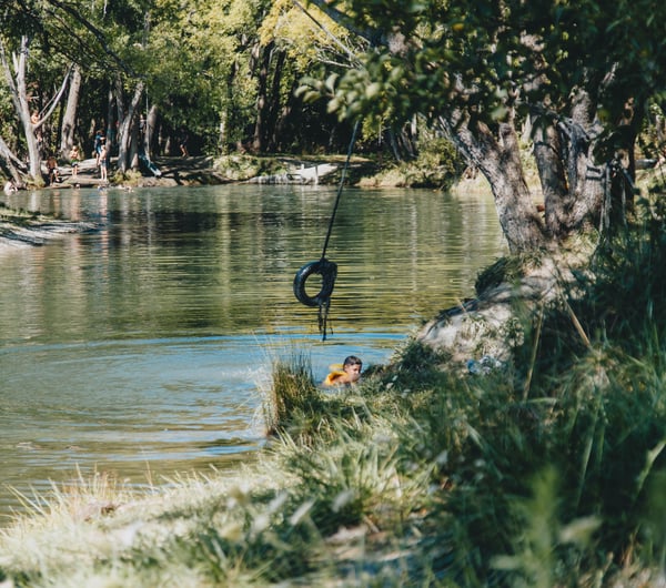 A boy swimming in a lake.