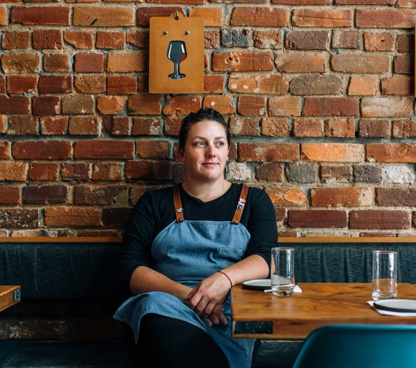 Leslie Hottiaux sitting in her restaurant.