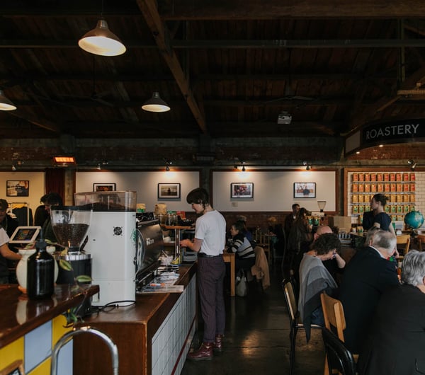 View of big table of customers at Addington Coffee Co-op in Christchurch.