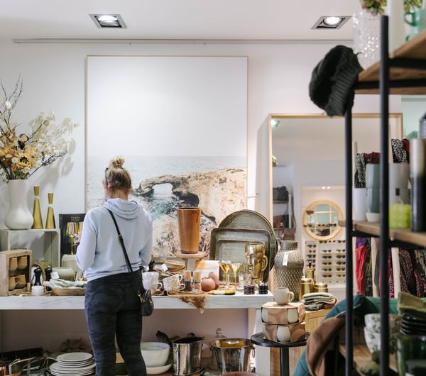 Woman looking at homewares inside Addy & Lou.