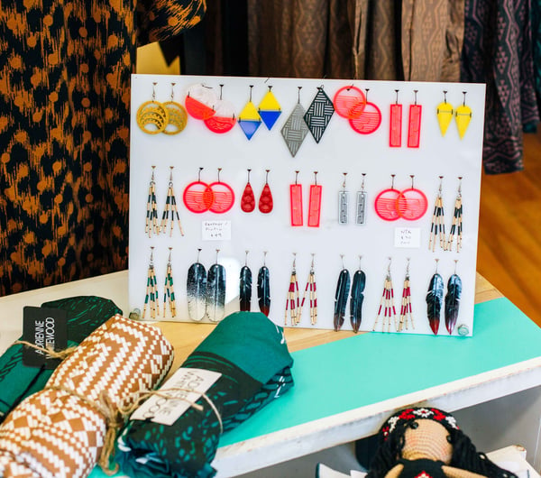 Dangly earrings on display on a table inside the store.