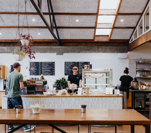Two employees working behind the cafe counter at Allpress Espresso in Christchurch.
