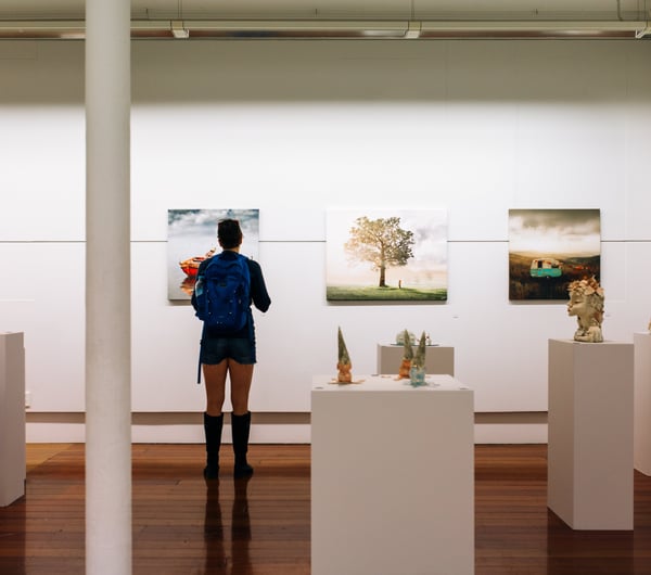 Woman looks at art at ArtsPost Gallery and Shop Hamilton.