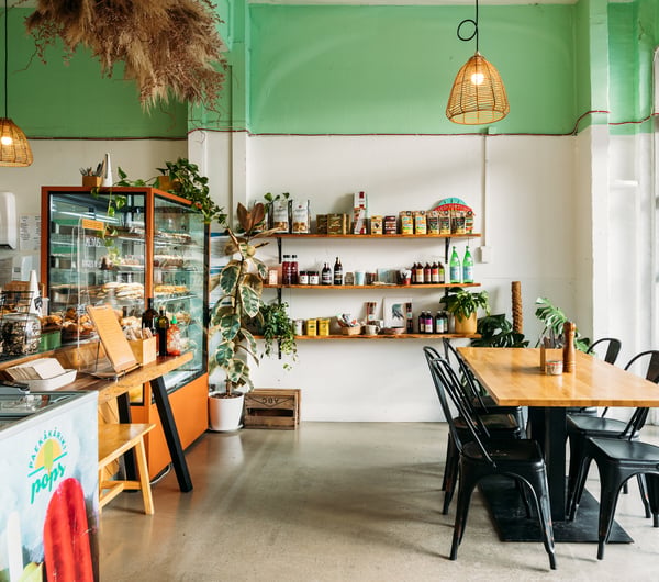 The brightly lit interior of Beach Road Deli on a sunny day.