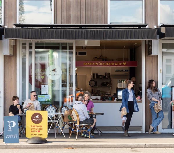 Customers sitting at tables outside Bellbird Bakery Holmwood.