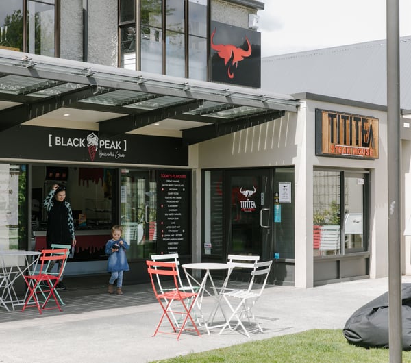 The exterior of Black Peak Gelato with tables and chairs and beanbags for customers.