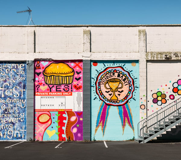 Colourful murals painted on a block wall.