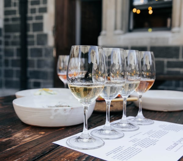 Row of wine tasting glasses outside on a table at Cellar Door in Christchurch.