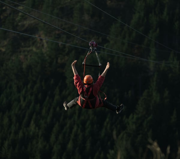 A person flying down one of the zip lines at Christchurch Adventure Park.