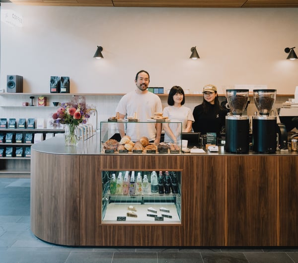 Three team members standing behind counter at Coffee Embassy Cashel Street in Christchurch