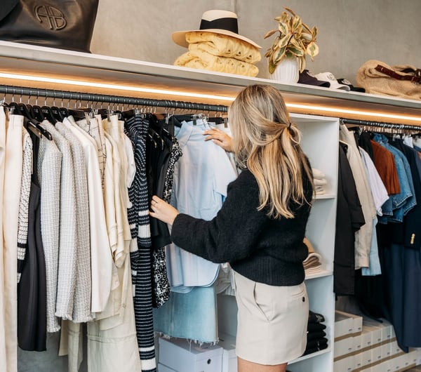 A woman looks through a rack of clothing in DEVàl Boutique, Wānaka.