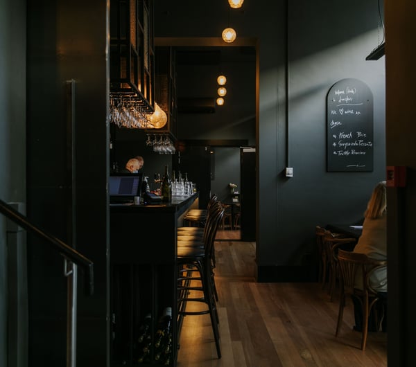 Dark moody image inside Downstairs where their is bright feature lighting.