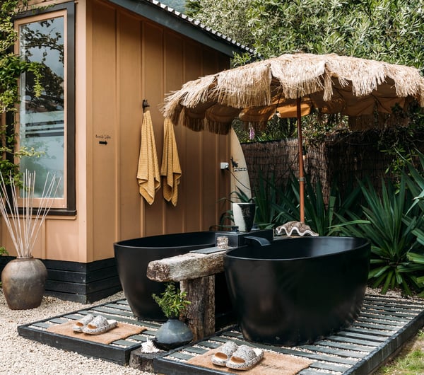 Black bath tubs and a small hut.