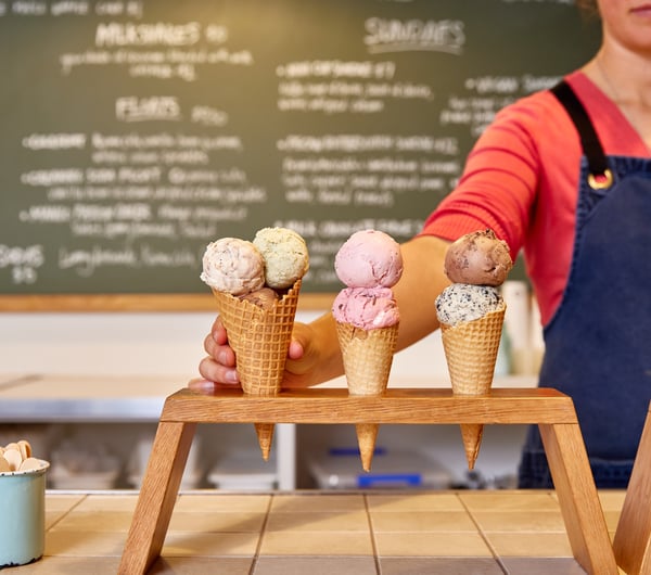Shop assistant placing ice cream cones on the counter at Duck Island.