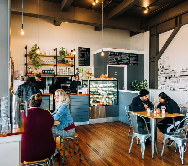 Busy cafe scene with lots of customers sitting at tables at Emmalou Macaron & Coffee, New Plymouth.