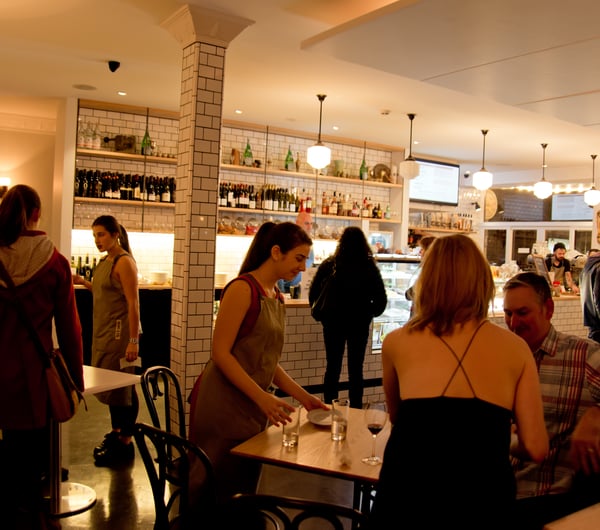 Serving tables in aprons.