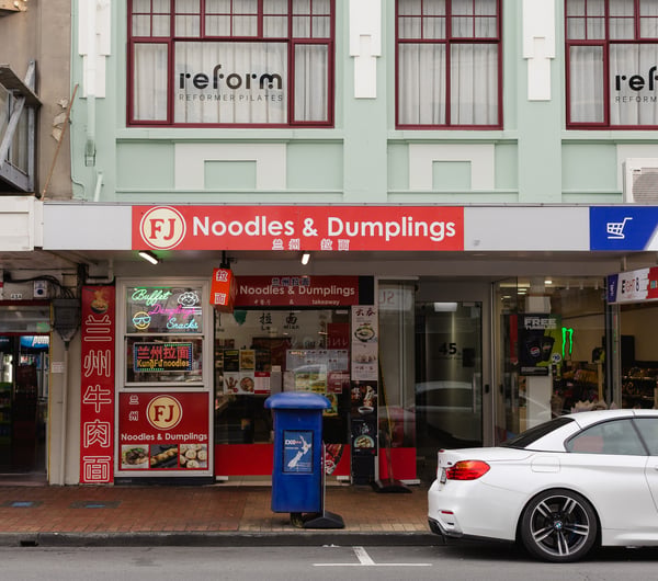 Bright red exterior of FJ Noodles & Dumplings.