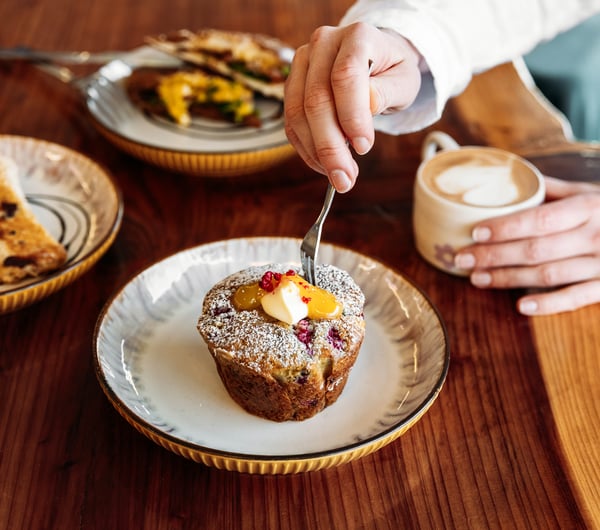 A close up of a muffin and coffee.