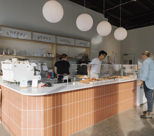 Customers ordering at the counter at Fluffy Bake Shop.