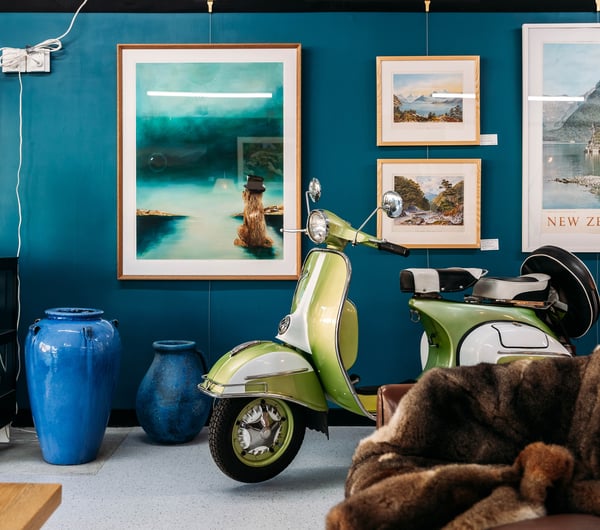 Vintage scooter and furniture inside a retail store.