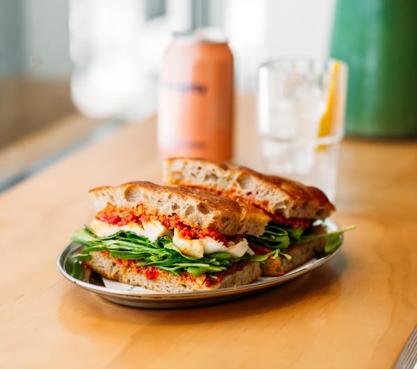 Sandwich on a wooden bench top at Fred's, Wellington.