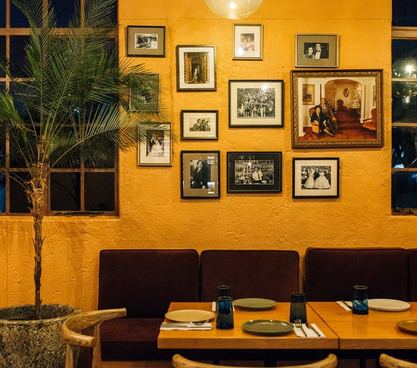 Close up of seating area and old photographs and artwork on the wall at Gemmayze Street.