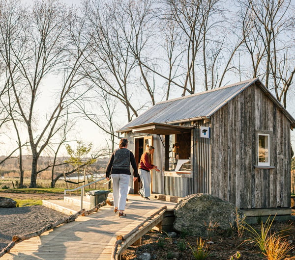 Customers walk up to small cottage building at Gorge Quarter.