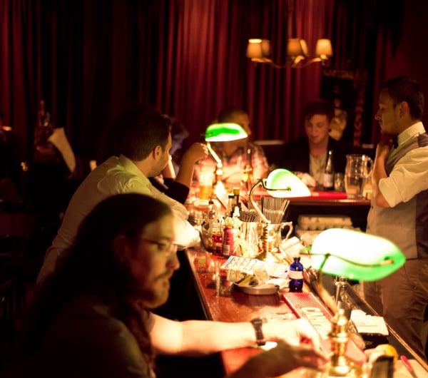 Green lamps on bar counter.