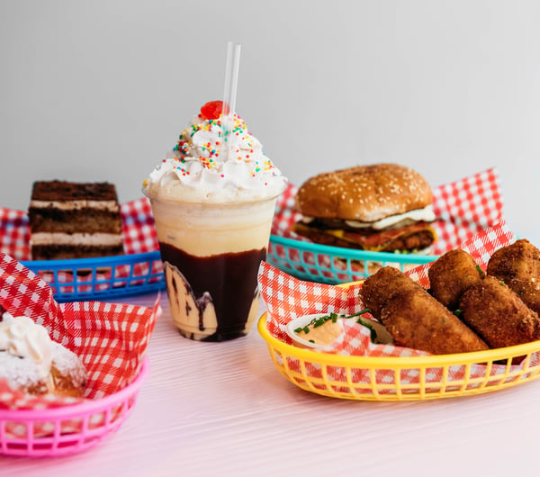 Burgers and thick shakes against a white background.