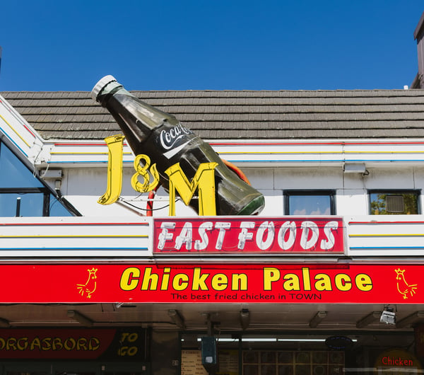 Colourful signage on the exterior of J & M Fastfood.