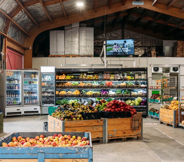 Fruit and vegetable stands inside the shopping area of Jackson Orchards.