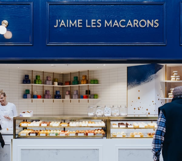 Blue shop exterior and glass cabinet of J’aime les macarons in Christchurch.