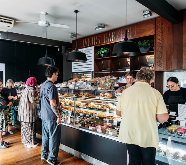 Customers waiting to order at the counter at Janus Bakkerij.