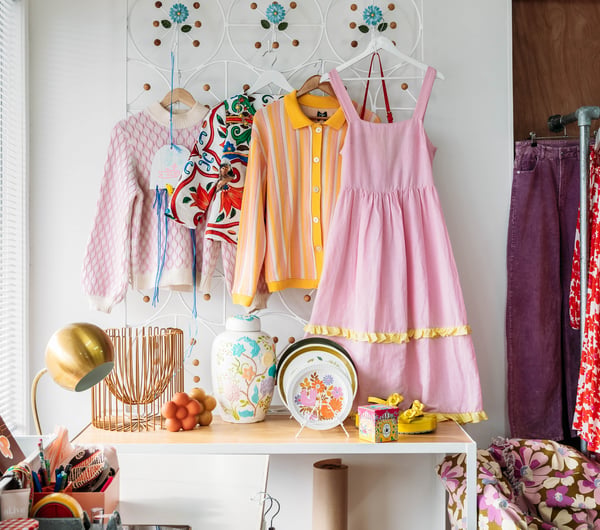 Pink and yellow clothes on a wall.
