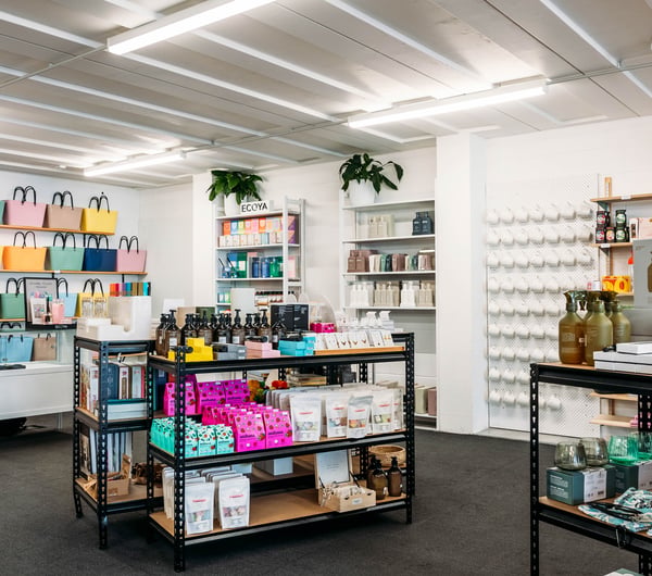 Products on display on shelves and tables in the store at Journey & Co.