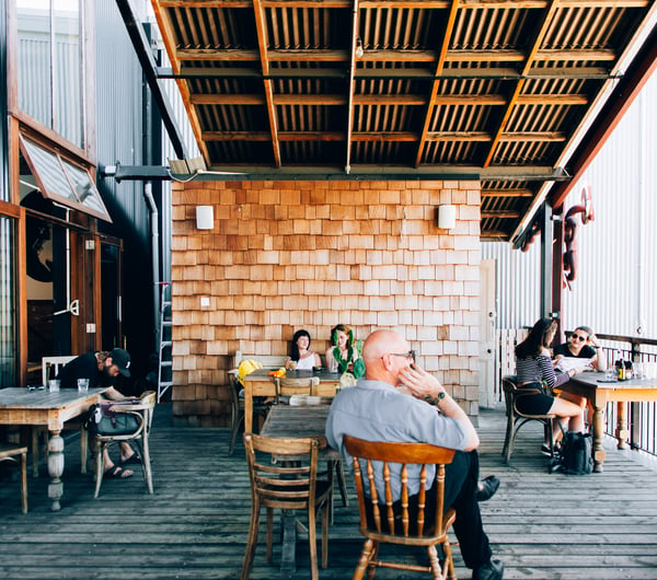 Customers hanging out on the deck at Lyttelton Coffee Company cafe.
