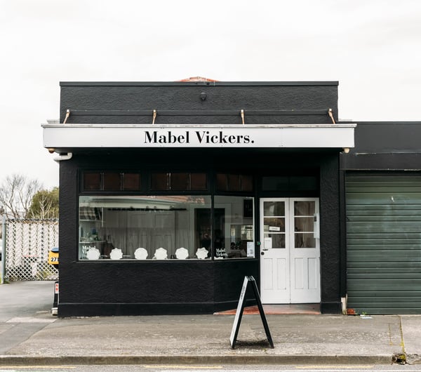 Black building on the corner of the street housing Mabel Vickers.