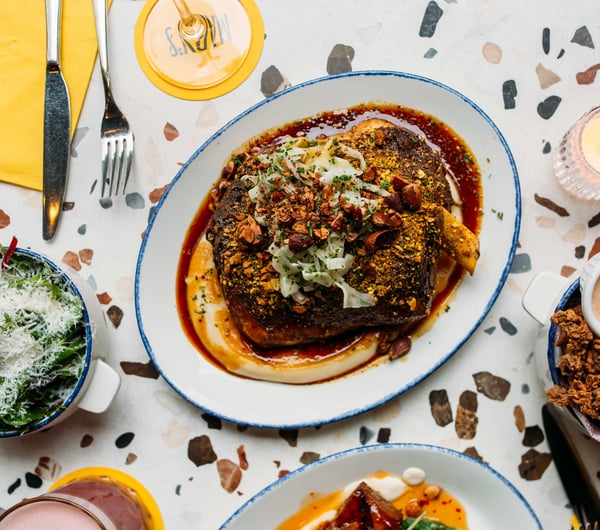 A flat lay of delicious looking plates of food on a table.